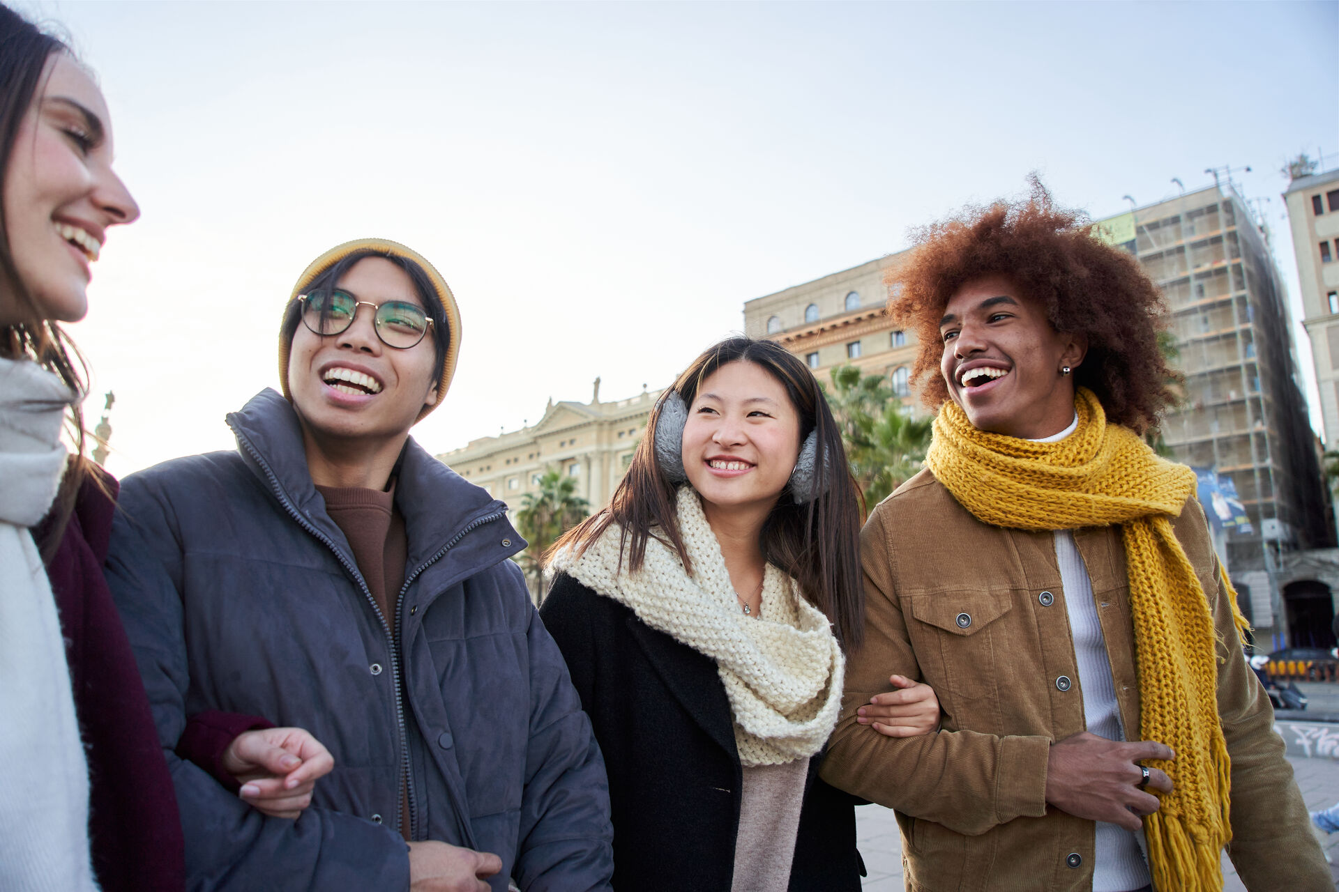 Multiracial colleagues strolling and talking in the city on a winter day outdoors