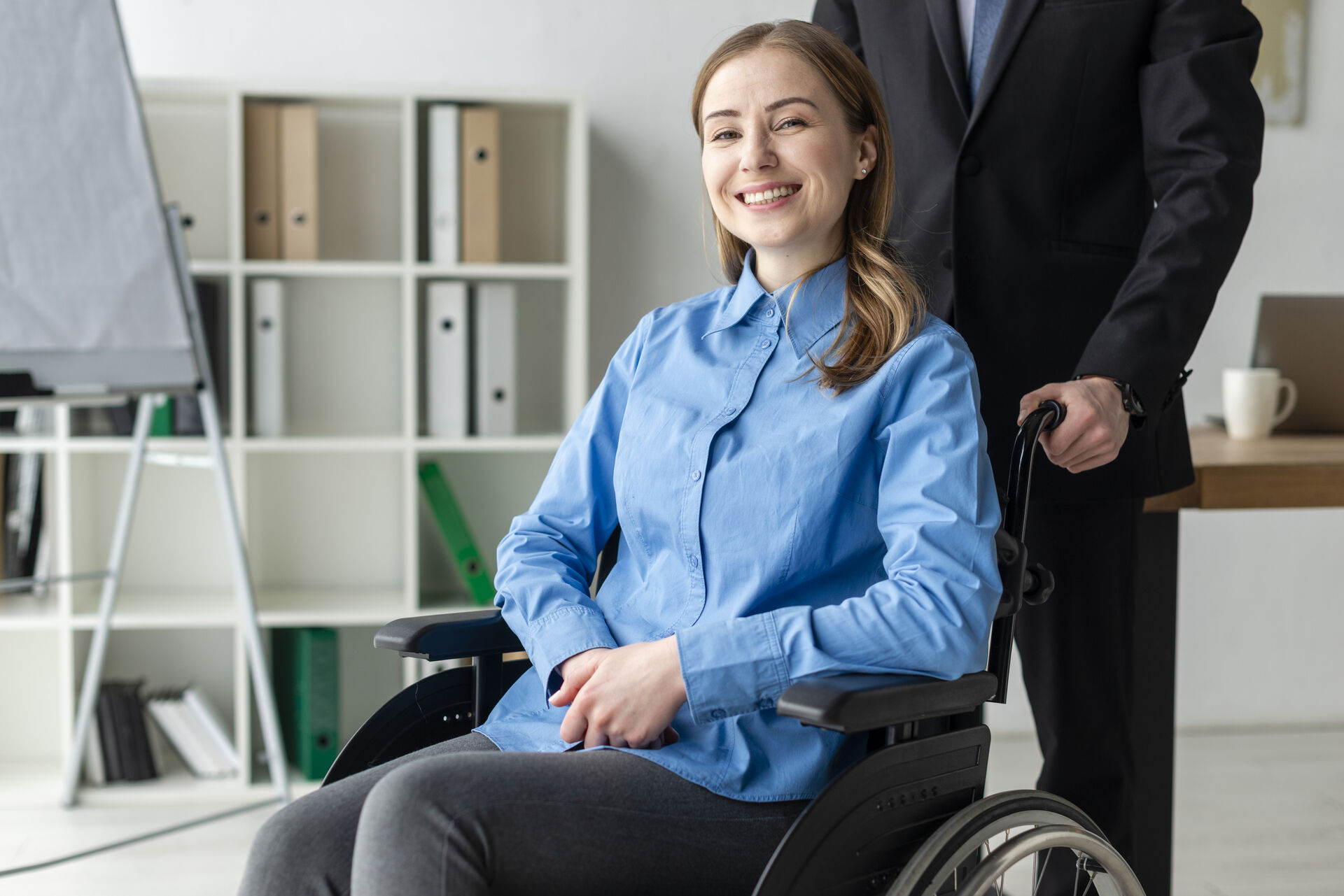 Portrait of a positive young woman smiling in a wheelchair