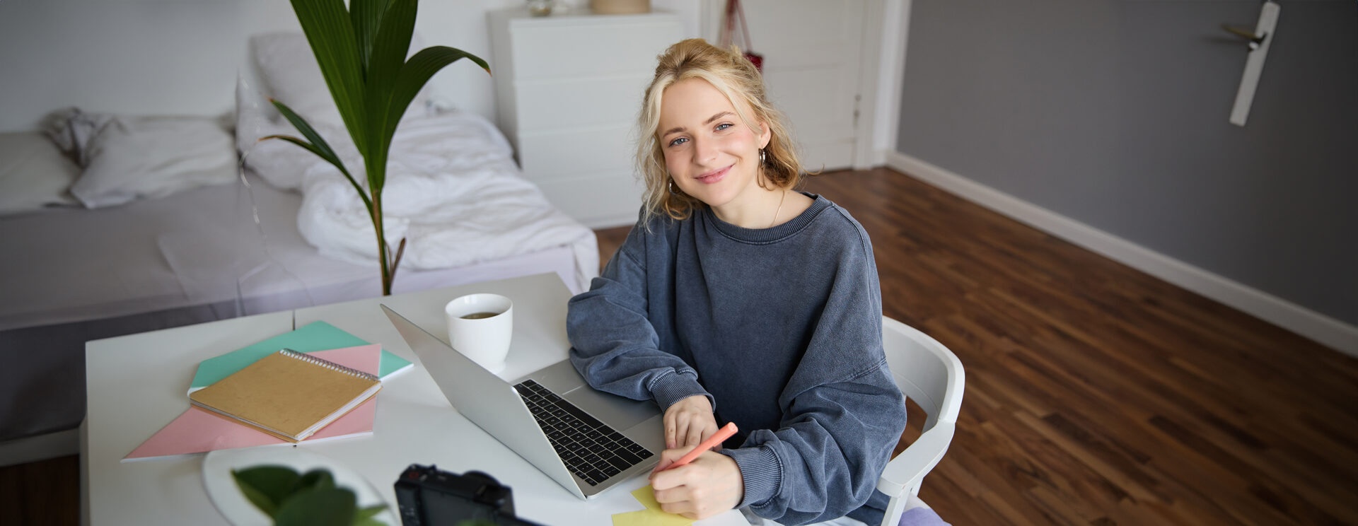 Happy smiling little boy at home doing homework in the morning before school