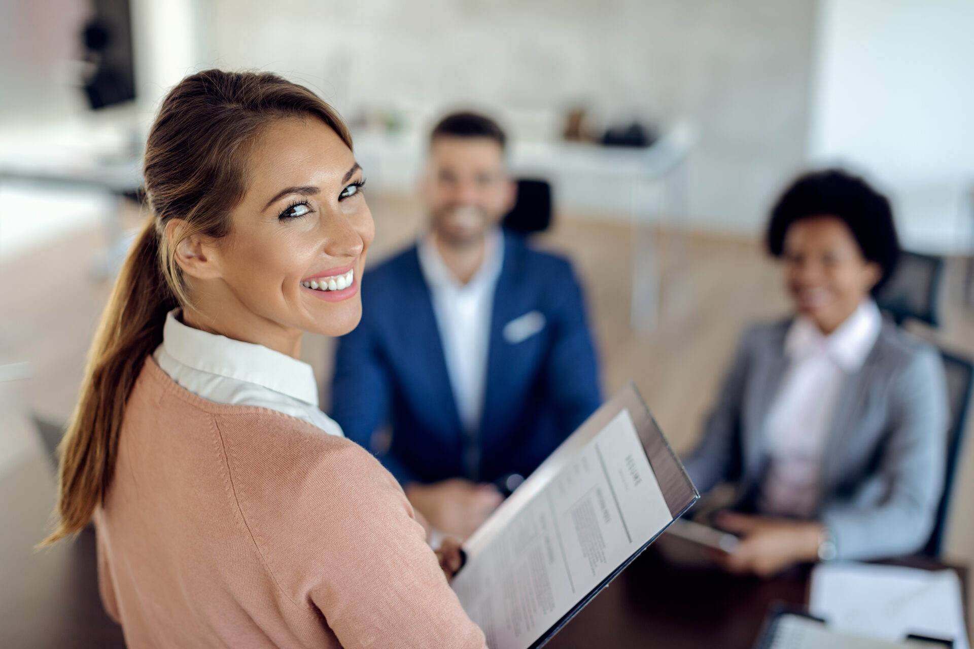 Young happy woman having job interview in office